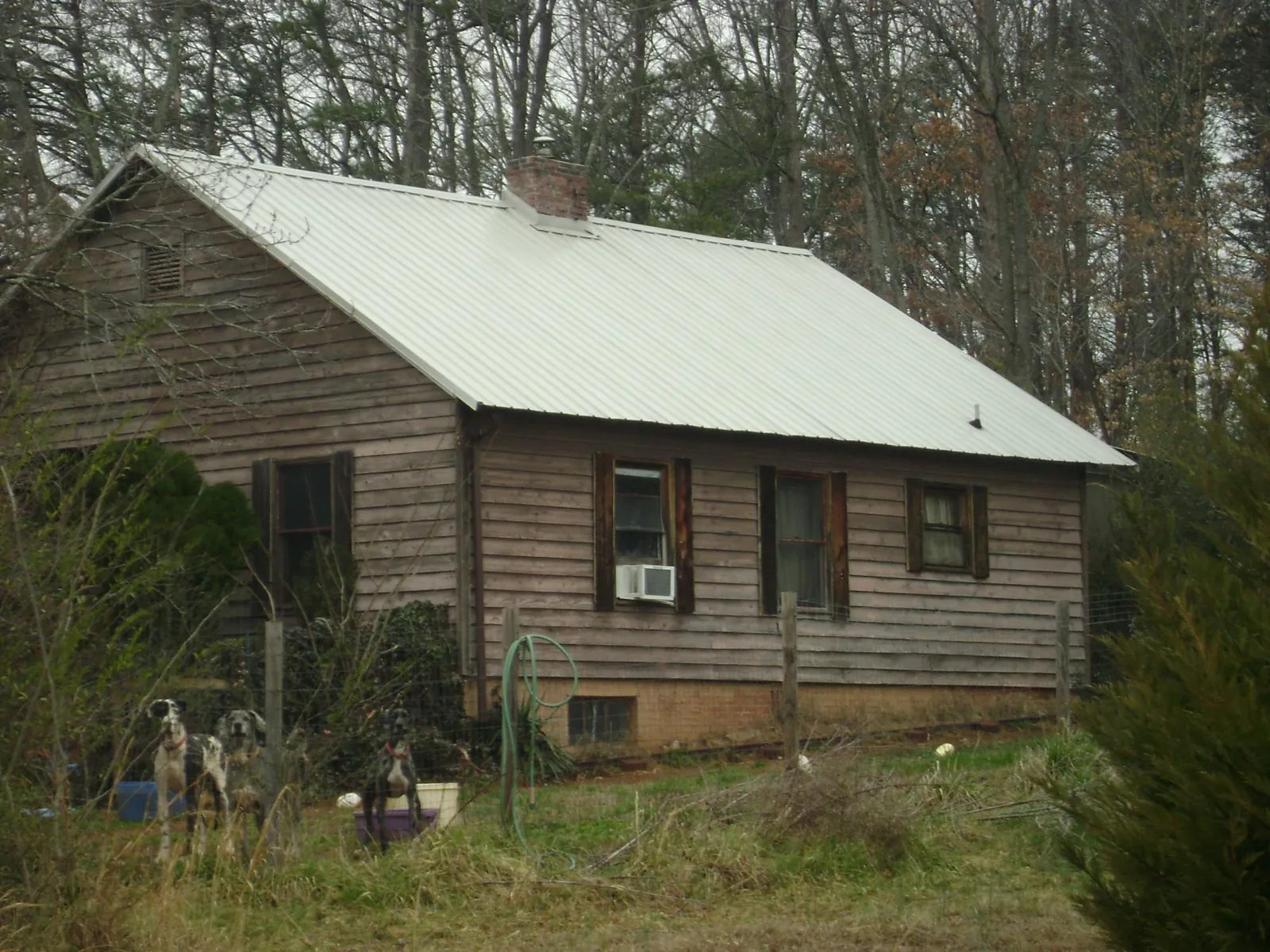 White metal roof on an old wood sided farmhouse, from a Asphalt Shingle Roof Repair job in Sunderland